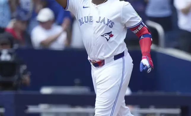 Toronto Blue Jays first base Vladimir Guerrero Jr. celebrates his solo home run during first inning MLB action baseball game against the San Francisco Giants in Toronto on Sunday, July 20, 2025. (Nathan Denette/The Canadian Press via AP)