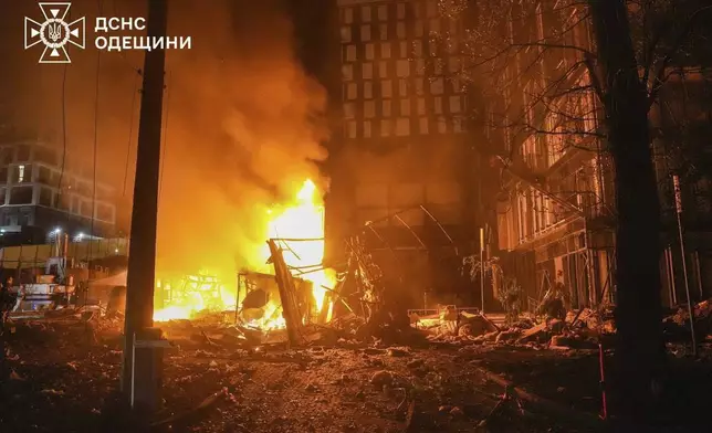 In this photo provided by the Ukrainian Emergency Service, firefighters try to put out a fire following a Russian attack in Odesa, Ukraine, Monday, July 7, 2025. (Ukrainian Emergency Service via AP)