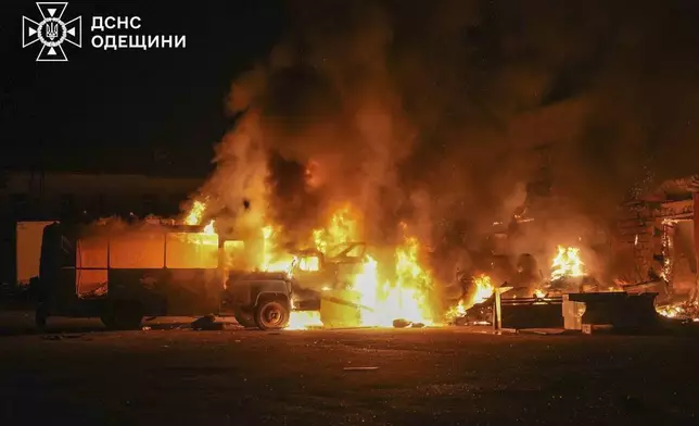 In this photo provided by the Ukrainian Emergency Service, firefighters put out a fire following a Russian attack in Odesa, Ukraine, Monday, July 7, 2025. (Ukrainian Emergency Service via AP)