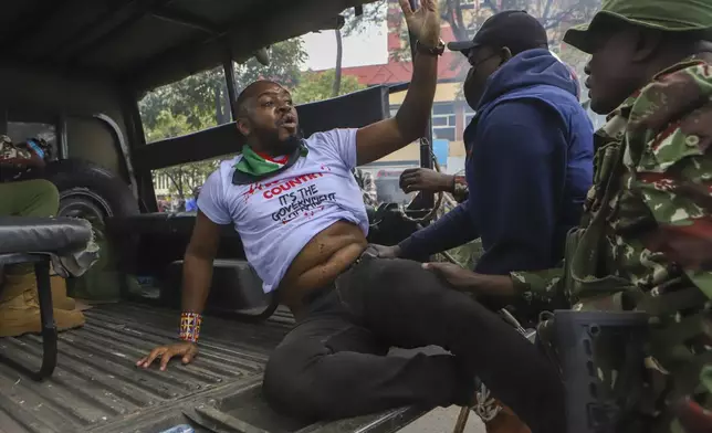 FILE - Police arrest activist Boniface Mwangi during a protest held to commemorate one month since youths were killed on June 25, outside parliament in Kenya's capital Nairobi, Thursday, July 25, 2024. (AP Photo/Andrew Kasuku, file)