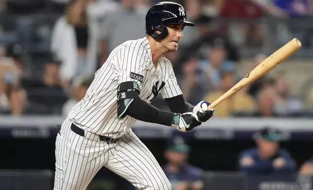 New York Yankees' Cody Bellinger hits a single during the ninth inning of a baseball game against the Seattle Mariners, Thursday, July 10, 2025, in New York. (AP Photo/Yuki Iwamura)