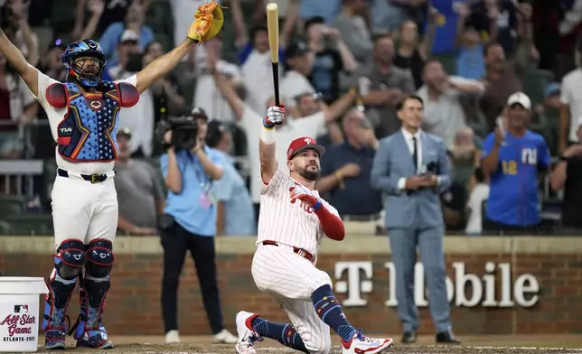 Philadelphia Phillies Kyle Schwarber celebrates after winning the tiebreaker at the MLB baseball All-Star game between the American League and National League, Tuesday, July 15, 2025, in Atlanta. (AP Photo/Brynn Anderson)