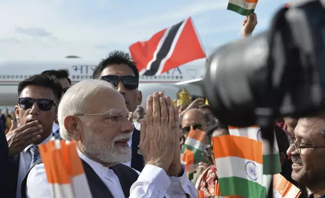 Indian Prime Minister Narendra Modi greets people upon arriving at Piarco International Airport in Piarco, Trinidad and Tobago, Thursday, July 3, 2025. (AP Photo/Jermaine Cruickshank)
