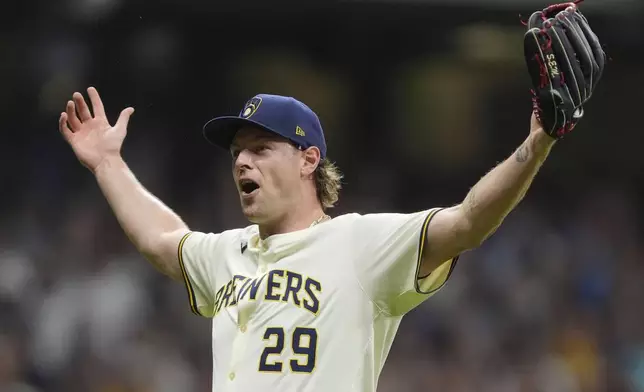Milwaukee Brewers' Trevor Megill gestures after recording a save during the ninth inning of a baseball game against the Los Angeles Dodgers, Tuesday, July 8, 2025, in Milwaukee. (AP Photo/Aaron Gash)