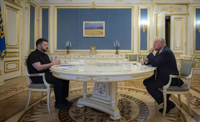 Ukrainian President Volodymyr Zelenskyy, left, and United States Special Envoy for Ukraine and Russia, Joseph Keith Kellogg talk in Kyiv, Ukraine, Monday, July 14, 2025. (Ukrainian Presidential Press Office via AP)