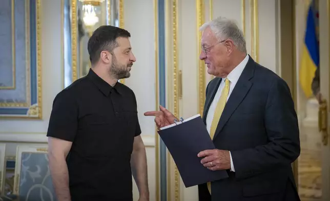 Ukrainian President Volodymyr Zelenskyy, left, and United States Special Envoy for Ukraine and Russia, Joseph Keith Kellogg talk in Kyiv, Ukraine, Monday, July 14, 2025. (Ukrainian Presidential Press Office via AP)