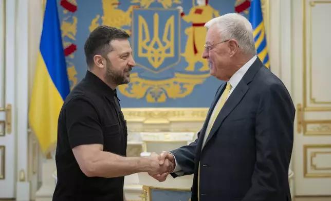 Ukrainian President Volodymyr Zelenskyy, left, shakes hands with United States Special Envoy for Ukraine and Russia, Joseph Keith Kellogg in Kyiv, Ukraine, Monday, July 14, 2025. (Ukrainian Presidential Press Office via AP)