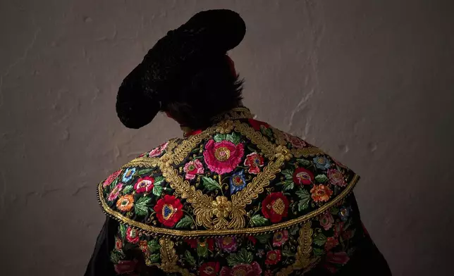 Peruvian bullfighter Andres Roca Rey pauses before entering the bullring during a bullfight at the San Fermin Festival in Pamplona, northern Spain, Friday, July 11, 2025. (AP Photo/Miguel Oses)