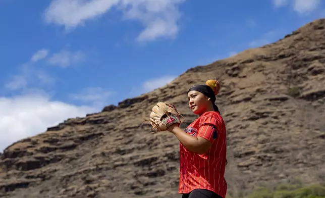 Ry-n Uyeda warms up during a softball practice, Friday, July 11, 2025, in Waianae, Hawaii. (AP Photo/Mengshin Lin)