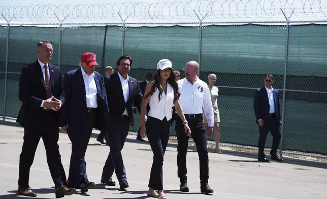 President Donald Trump, Gov. Ron DeSantis, R-Fla., Homeland Security Secretary Kristi Noem and others, tour "Alligator Alcatraz," a new migrant detention facility at Dade-Collier Training and Transition facility, Tuesday, July 1, 2025, in Ochopee, Fla. (AP Photo/Evan Vucci)