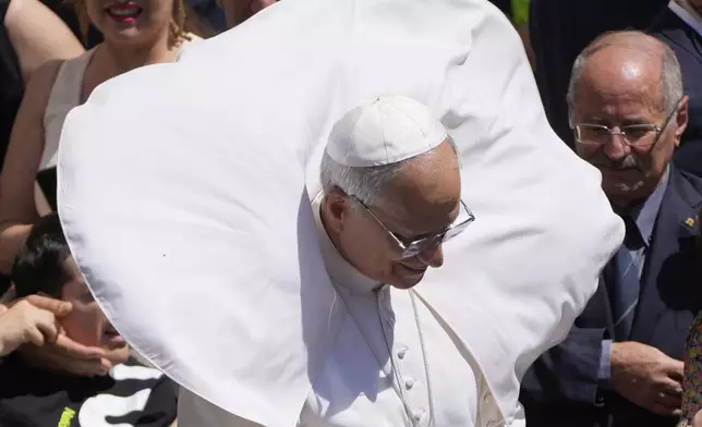 A gust of wind blows Pope Leo XIV's mantel at the end of the noon Angelus prayer in the square in front of the Apostolic Palace in Castel Gandolfo, Italy, Sunday, July 20, 2025. (AP Photo/Gregorio Borgia)