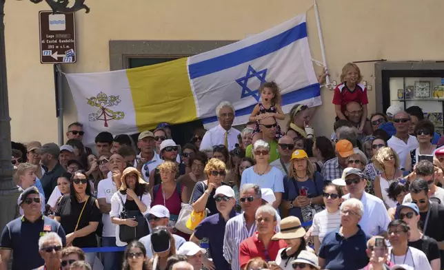 Faithful hold Israel and Vatican flags during the noon Angelus prayer with Pope Leon XIV, in the square in front of the Apostolic Palace for in Castel Gandolfo, Italy, Sunday, July 20, 2025. (AP Photo/Gregorio Borgia)