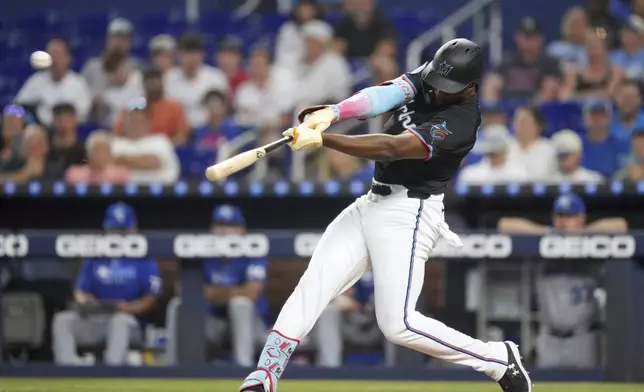 Miami Marlins' Jesus Sanchez hits a home run in the first inning of a baseball game against the Kansas City Royals, Friday, July 18, 2025, in Miami. (AP Photo/Rebecca Blackwell)