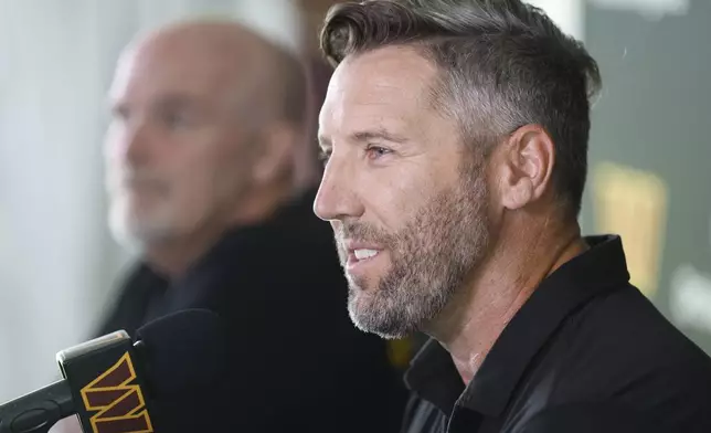 Washington Commanders general manager Adam Peters, right, speaks as head coach Dan Quinn, left, looks on during a news conference at the NFL football team's training camp in Ashburn, Va., Tuesday, July 22, 2025. (AP Photo/Luis M. Alvarez)