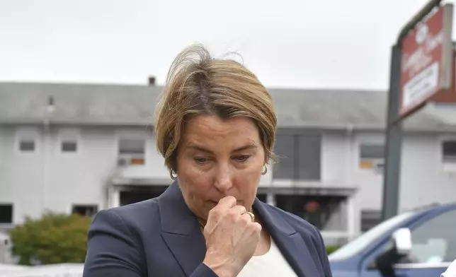 FILE - Massachusetts Gov. Maura Healey approaches a news conference to face reporters, July 14, 2025, near the Gabriel House assisted living facility, behind, following a fire that started late Sunday in Fall River, Mass. (AP Photo/Steven Senne, file)
