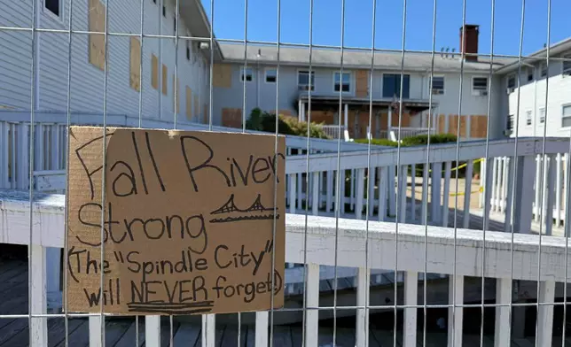 A handwritten sign is propped outside the Gabriel House on Tuesday, July 22, 2025, more than a week after a deadly fire at that assisted-living facility in Fall River, Mass. (AP Photo/Rodrique Ngowi)