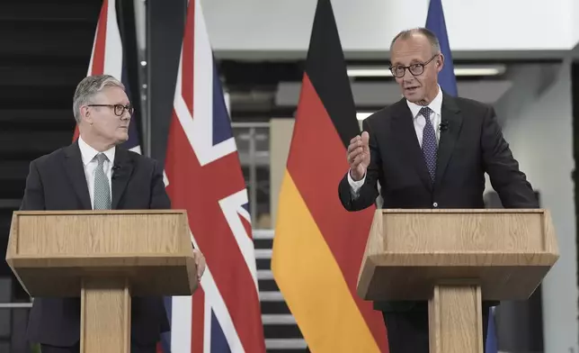 Britain's Prime Minister Keir Starmer, left, and German Chancellor Friedrich Merz hold a press conference during a visit to the Airbus factory in Stevenage, England, Thursday July 17, 2025. (Stefan Rousseau/Pool via AP)