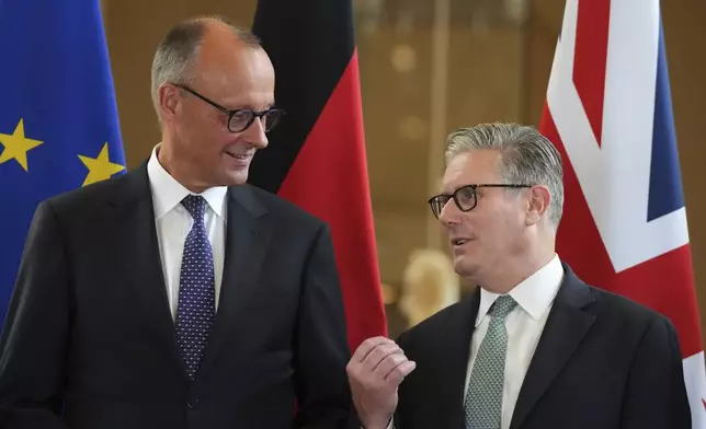 Britain's Prime Minister Keir Starmer, right, and German Chancellor Friedrich Merz, left, talk as they attend a signing ceremony of a wide-ranging bilateral cooperation treaty in London, Thursday, July 17, 2025.(AP Photo/Frank Augstein, Pool)