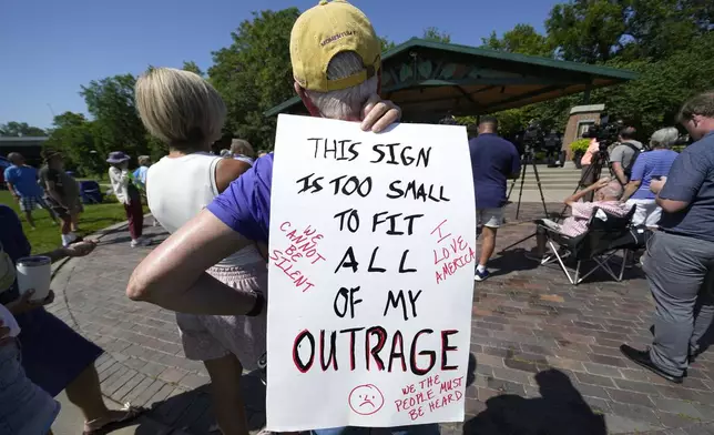 A local resident listen to a speech during an Iowa Democratic Party rally, Thursday, July 3, 2025, in Windsor Heights, Iowa. (AP Photo/Charlie Neibergall)