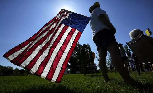 Theresa Peiffer, of Polk City, Iowa, listens to a speaker during an Iowa Democratic Party rally, Thursday, July 3, 2025, in Windsor Heights, Iowa. (AP Photo/Charlie Neibergall)