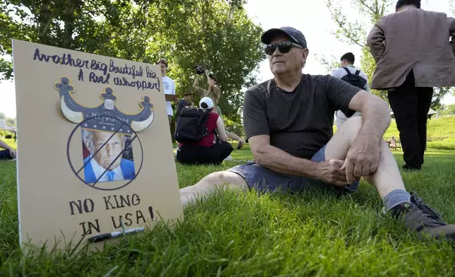 Dana Myers, of Des Moines, Iowa, waits for the start of an Iowa Democratic Party rally, Thursday, July 3, 2025, in Windsor Heights, Iowa. (AP Photo/Charlie Neibergall)