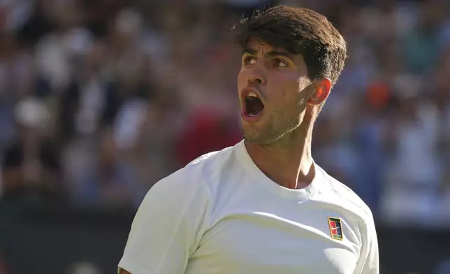 Carlos Alcaraz of Spain celebrates after beating Fabio Fognini of Italy during their first round men's singles match at the Wimbledon Tennis Championships in London, Monday, June 30, 2025. (AP Photo/Alastair Grant)