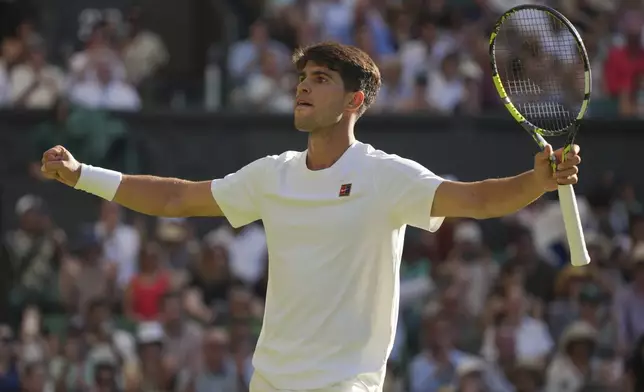 Carlos Alcaraz of Spain celebrates after beating Fabio Fognini of Italy during their first round men's singles match at the Wimbledon Tennis Championships in London, Monday, June 30, 2025. (AP Photo/Alastair Grant)