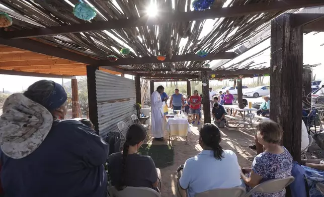 The Rev. Aro Varnabas leads the St. John the Baptist's feast day Mass in Saguaro National Park near Tucson, Ariz., on Tuesday, June 24, 2025. (AP Photo/Ross D. Franklin)