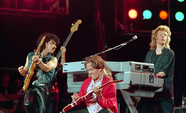 FILE - John Oates, from left, G.E.Smith and Daryl Hall perform at JFK Stadium in Philadelphia for the Live Aid famine relief concert on July 13, 1985. (AP Photo/Amy Sancetta, File)