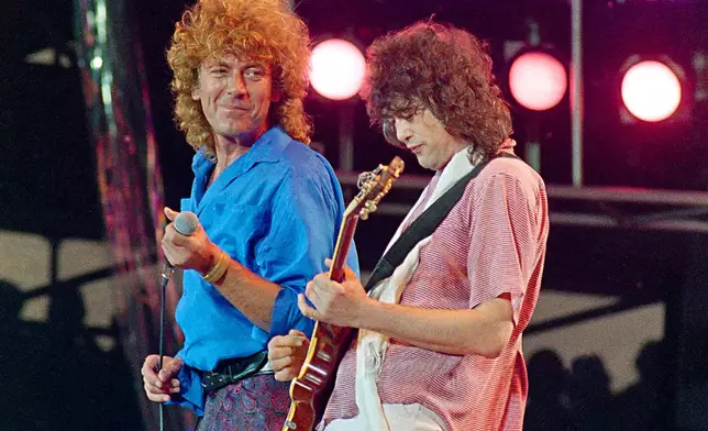 FILE - Led Zeppelin bandmates, singer Robert Plant, left, and guitarist Jimmy Page, perform for the Live Aid famine relief concert at JFK Stadium in Philadelphia on July 13, 1985. (AP Photo/Amy Sancetta, File)