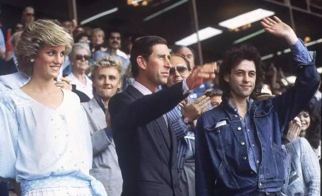 FILE - Princess Diana, left, and Prince Charles attend the Live Aid concert as they acknowledge the crowd with event organizer Bob Geldof, right, at London's Wembley Stadium, on July 13, 1985. (AP Photo/Joe Schaber, File)