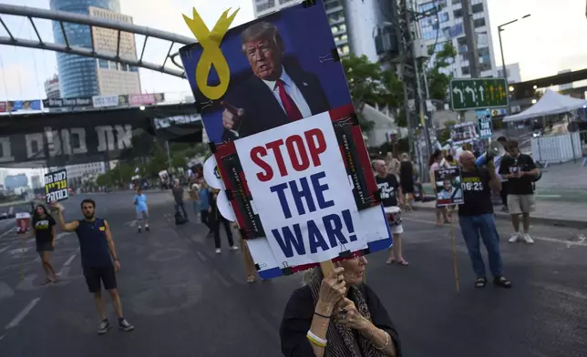 Relatives of hostages held by Hamas in the Gaza Strip and their supporters call for an immediate hostage release deal during a protest in Tel Aviv, Israel, Thursday, July 10, 2025. (AP Photo/Ariel Schalit)