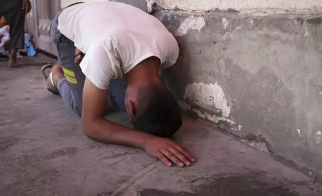 Youssef Abd Rabbo weeps at the hospital where the body of his mother Manal was taken together with 10 more people, including two women and five children, killed in an Israeli strike while they were waiting to receive nutritional supplements at a Project Hope-run medical clinic in Deir al-Balah, Gaza Strip, Thursday, July 10, 2025.(AP Photo/Abdel Kareem Hana)