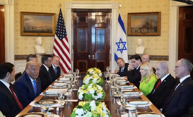 President Donald Trump, second from left, meets with Israel's Prime Minister Benjamin Netanyahu, second from right, as Secretary of State Marco Rubio, from left, Defense Secretary Pete Hegseth, obstructed, CIA Director John Ratcliffe, U.S. Ambassador to Israel Mike Huckabee, and from right, Israeli Ambassador to the U.S. Yechiel Leiter, Netanyahu's wife Sara Netanyahu, Israel's Strategic Affairs Minister Ron Dermer, Israel's National Security Council head Tzachi Hanegbi and Israel's Cabinet Secretary Yossi Fuchs listen in the Blue Room of the White House, Monday, July 7, 2025, in Washington. (AP Photo/Alex Brandon)