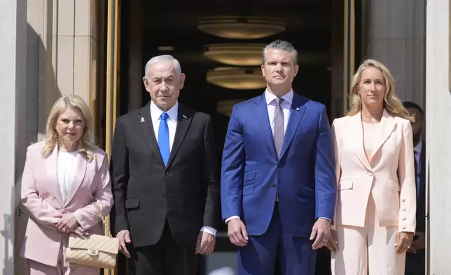 Israeli Prime Minister Benjamin Netanyahu and his wife Sara stand with Secretary of Defense Pete Hegseth and his wife Jennifer during an honor cordon ceremony upon his arrival at the Pentagon, Wednesday, July 9, 2025, in Washington. (AP Photo/Mark Schiefelbein)
