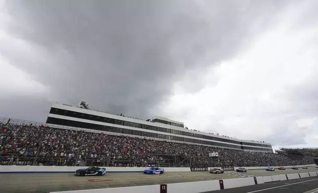 Denny Hamlin (11) drives behind the pace car during a yellow flag for rain during a NASCAR Cup Series auto race at Dover Motor Speedway, Sunday, July 20, 2025, in Dover, Del. (AP Photo/Derik Hamilton)