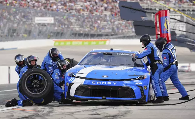 Denny Hamlin makes a pit stop during a NASCAR Cup Series auto race at Dover Motor Speedway, Sunday, July 20, 2025, in Dover, Del. (AP Photo/Derik Hamilton)