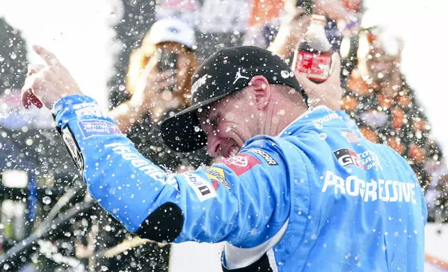 Denny Hamlin celebrates in Victory Lane after winning a NASCAR Cup Series auto race at Dover Motor Speedway, Sunday, July 20, 2025, in Dover, Del. (AP Photo/Derik Hamilton)