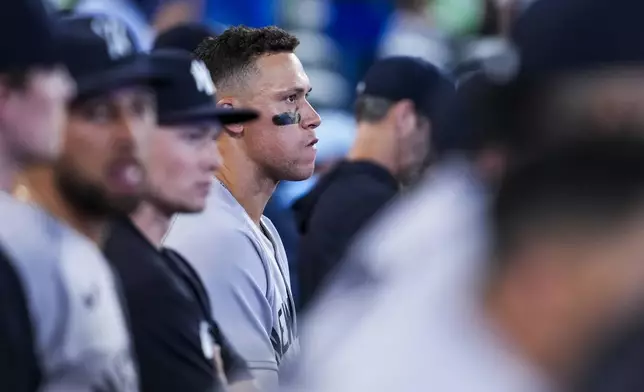 New York Yankees outfielder Aaron Judge, center, looks on from the dugout during ninth-inning baseball game action against the Toronto Blue Jays in Toronto, Thursday, July 3, 2025. (Thomas Skrlj/The Canadian Press via AP)