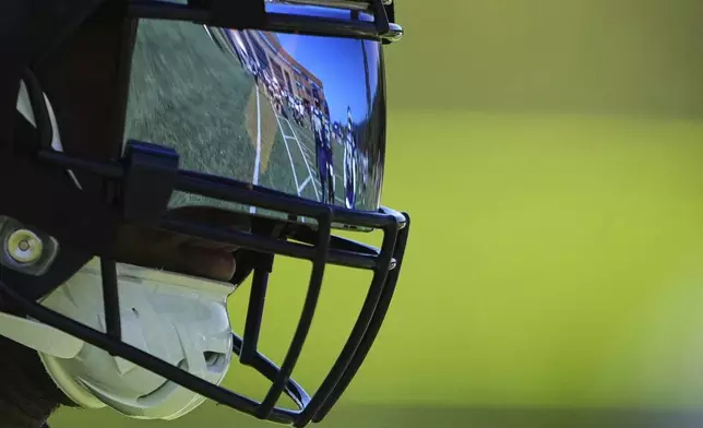 The field is reflected in the visor of Seattle Seahawks running back Kenneth Walker III during the NFL football team's training camp, Monday, July 28, 2025, in Renton, Wash. (AP Photo/Lindsey Wasson)