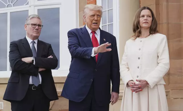 President Donald Trump, center, speaks with the media as he greets Britain's Prime Minister Keir Starmer, left, and his wife Victoria at the Trump Turnberry golf course in Turnberry, Scotland Monday, July 28, 2025. (AP Photo/Jacquelyn Martin)