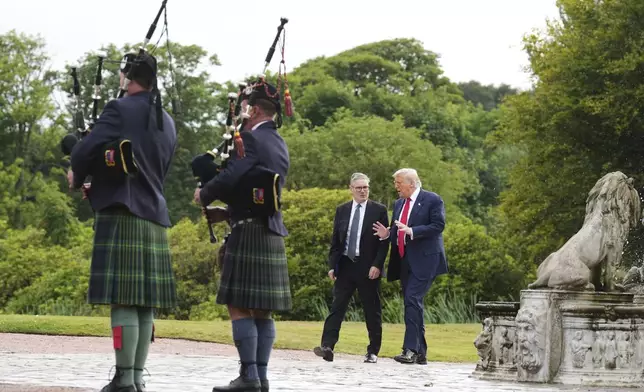 President Donald Trump, right, and Britain's Prime Minister Keir Starmer arrive at Trump International Golf Links, near Aberdeen, Scotland, Monday, July 28, 2025. (AP Photo/Jacquelyn Martin)