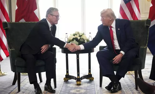 President Donald Trump shakes hands as he meets with Britain's Prime Minister Keir Starmer, left, at Trump Turnberry golf club on Monday, July 28, 2025 in Turnberry, Scotland. (Christopher Furlong/Pool Photo via AP)