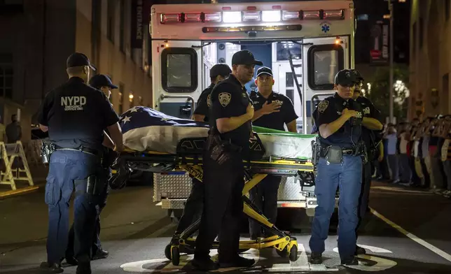 NYPD officers bring out the body of Didarul Islam, who was shot and killed by a gunman earlier this evening, out of NewYork-Presbyterian/Weill Cornell Medical Hospital, early Tuesday, July 29, 2025, in New York. (AP Photo/Angelina Katsanis)