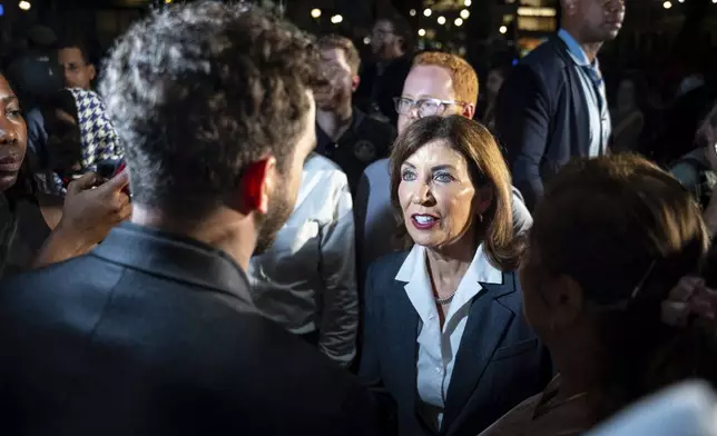Governor Kathy Hochul talks with grievers after the vigil for the four people killed in the previous day's shooting at 345 Park Avenue, including NYPD officer Didarul Islam, in Bryant Park, Tuesday, July 29, 2025, in New York. (AP Photo/Angelina Katsanis)