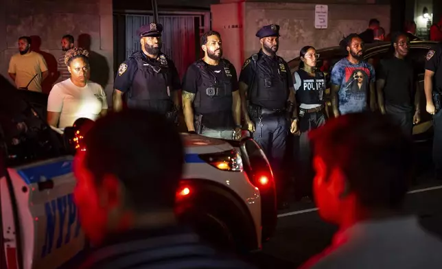 NYPD officers line up during the dignified transfer of Didarul Islam, who was shot and killed by a gunman earlier this evening, out of NewYork-Presbyterian/Weill Cornell Medical Hospital to the medical examiner's office, Tuesday, July 28, 2025, in New York. (AP Photo/Angelina Katsanis)