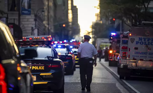 The scene on 52nd Street between Park and Lexington Avenue where a New York Police Department police officer was shot, Monday, July 28, 2025, in New York. (AP Photo/Angelina Katsanis)