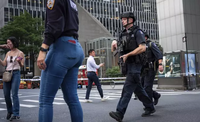 The scene on the corner of Lexington Avenue and 53rd Street, near 345 Park Avenue where aNew York Police Department police officer was shot, Monday, July 28, 2025, in New York. (AP Photo/Angelina Katsanis)