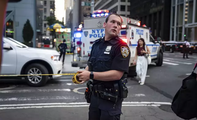 The scene on the corner of Lexington Avenue and 53rd Street, near 345 Park Avenue where a New York Police Department police officer was shot, Monday, July 28, 2025, in New York. (AP Photo/Angelina Katsanis)