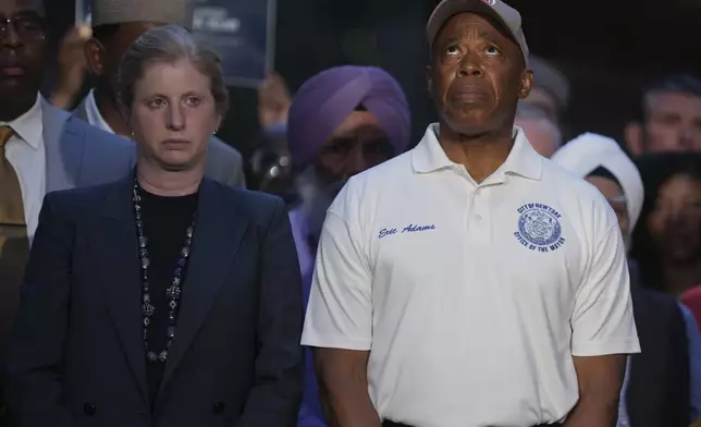 New York Police commissioner Jessica Tisch, left, and New York Mayor Eric Adams attend a vigil, Tuesday, July 29, 2025, in New York. (AP Photo/Angelina Katsanis)